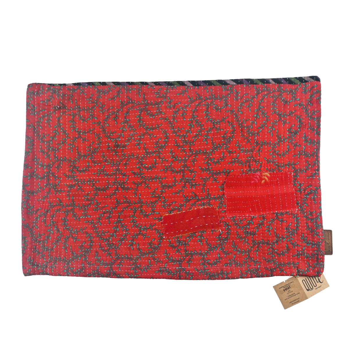Red Sari Kantha cushion cover with intricate black patterns and bright stitching. Choose this cushion for its rich texture and unique craftsmanship. Size: 60 x 40 cm.